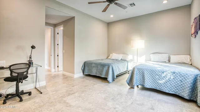 a bedroom with double bed and a chandelier