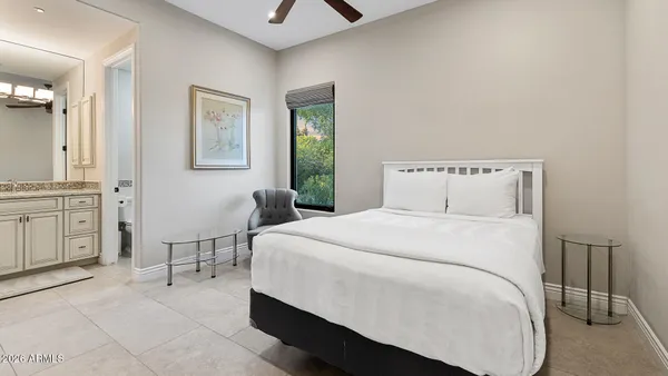 a bedroom with a bed a table and chair