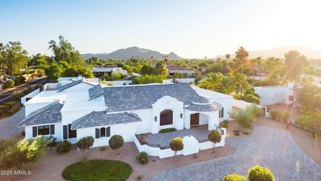 a aerial view of a house with swimming pool and a yard