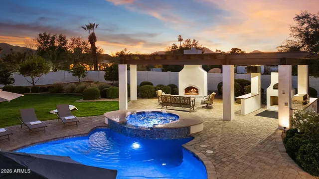 a view of a patio with table and chairs potted plants and floor to ceiling window