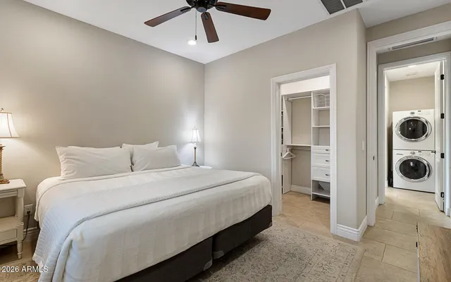 a bedroom with a bed and a chandelier