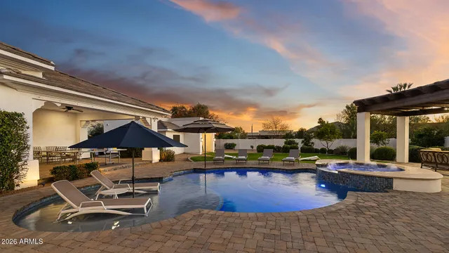 a view of a swimming pool with lounge chairs in patio