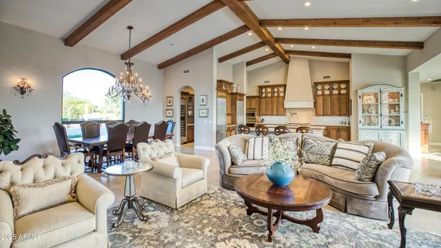 a living room with fireplace furniture and a large window