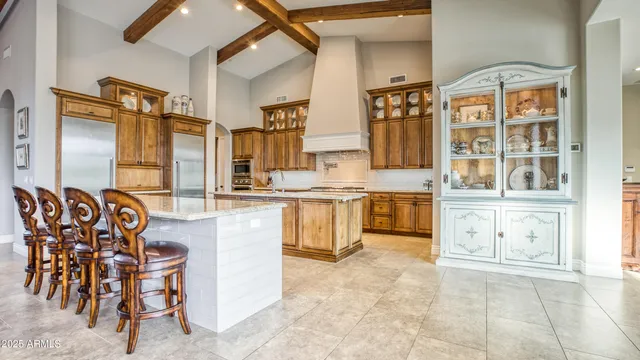 a kitchen with cabinets and chairs