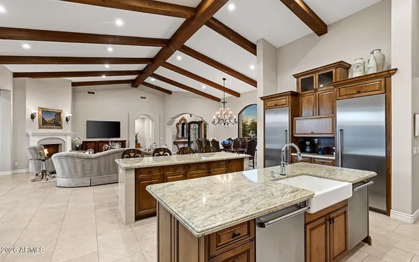 a kitchen with stainless steel appliances granite countertop a stove and a refrigerator