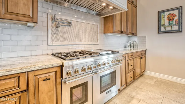 a kitchen with stainless steel appliances granite countertop a stove and a sink
