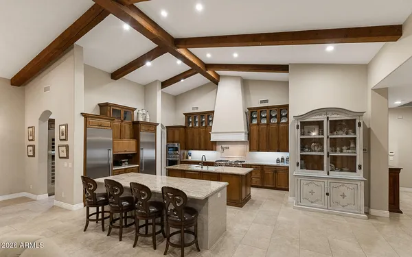 a kitchen with stainless steel appliances kitchen island granite countertop a stove and a refrigerator