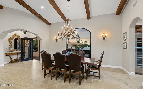 a view of a dining room with furniture and a chandelier