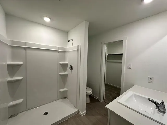 a bathroom with a sink toilet and mirror