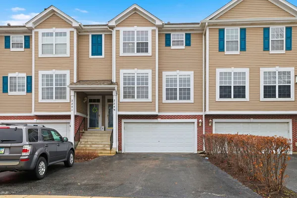 a front view of a house with a parking space