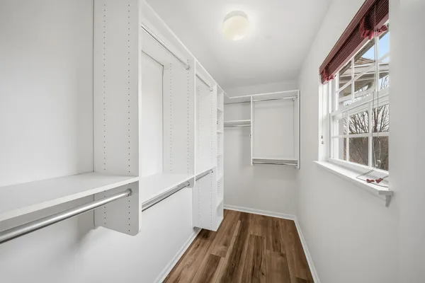 a view of walk in closet with empty racks