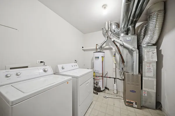 a view of storage and utility room with washer and dryer