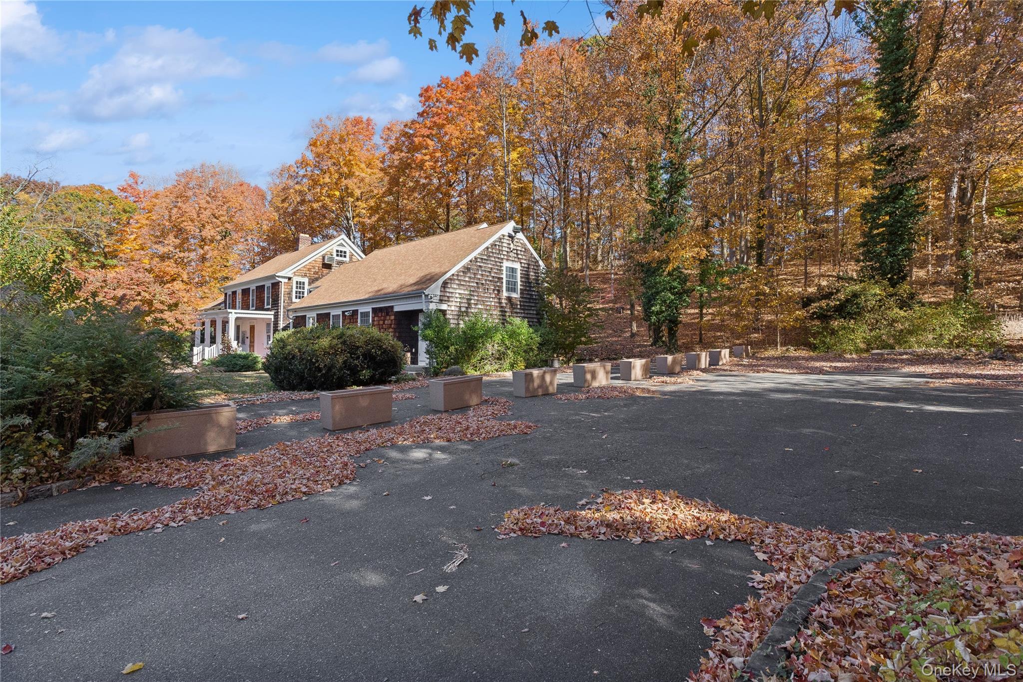 58 Goose Hill Road Cold Spring Harbor, NY 11724 - Photo 13 of 32 a front view of a house with a yard and street
