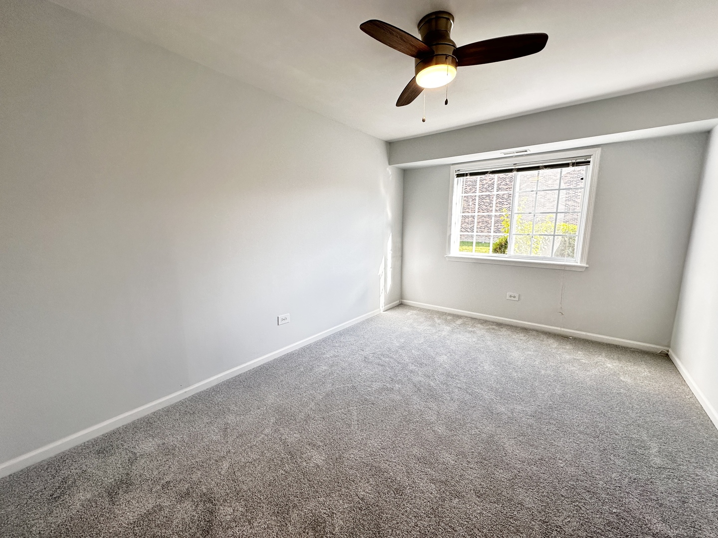 1603 North Windsor Drive, Unit 102 Arlington Heights, IL 60004 - Photo 11 of 18 a view of an empty room with a window