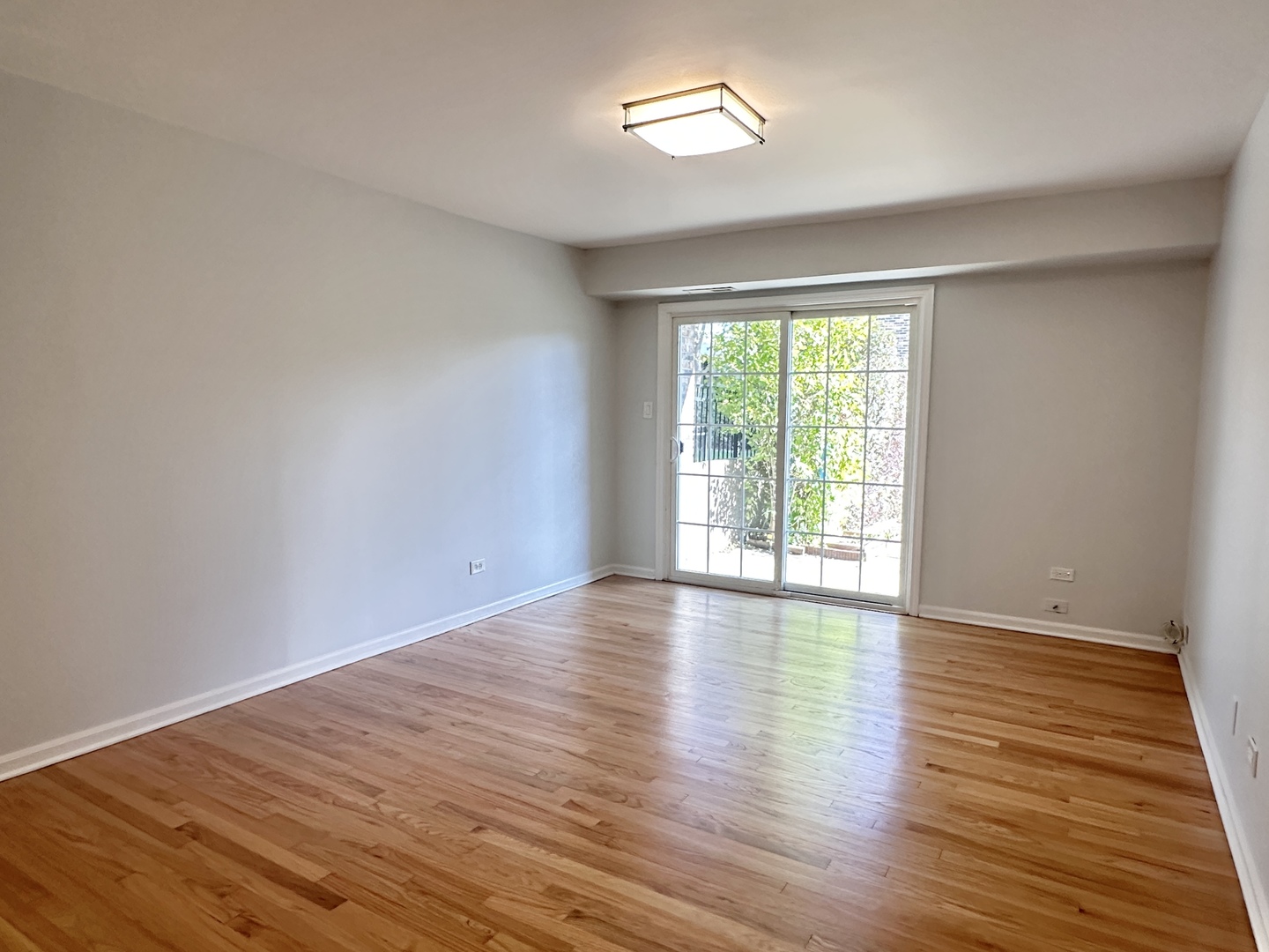 1603 North Windsor Drive, Unit 102 Arlington Heights, IL 60004 - Photo 3 of 18 a view of empty room with wooden floor and fan
