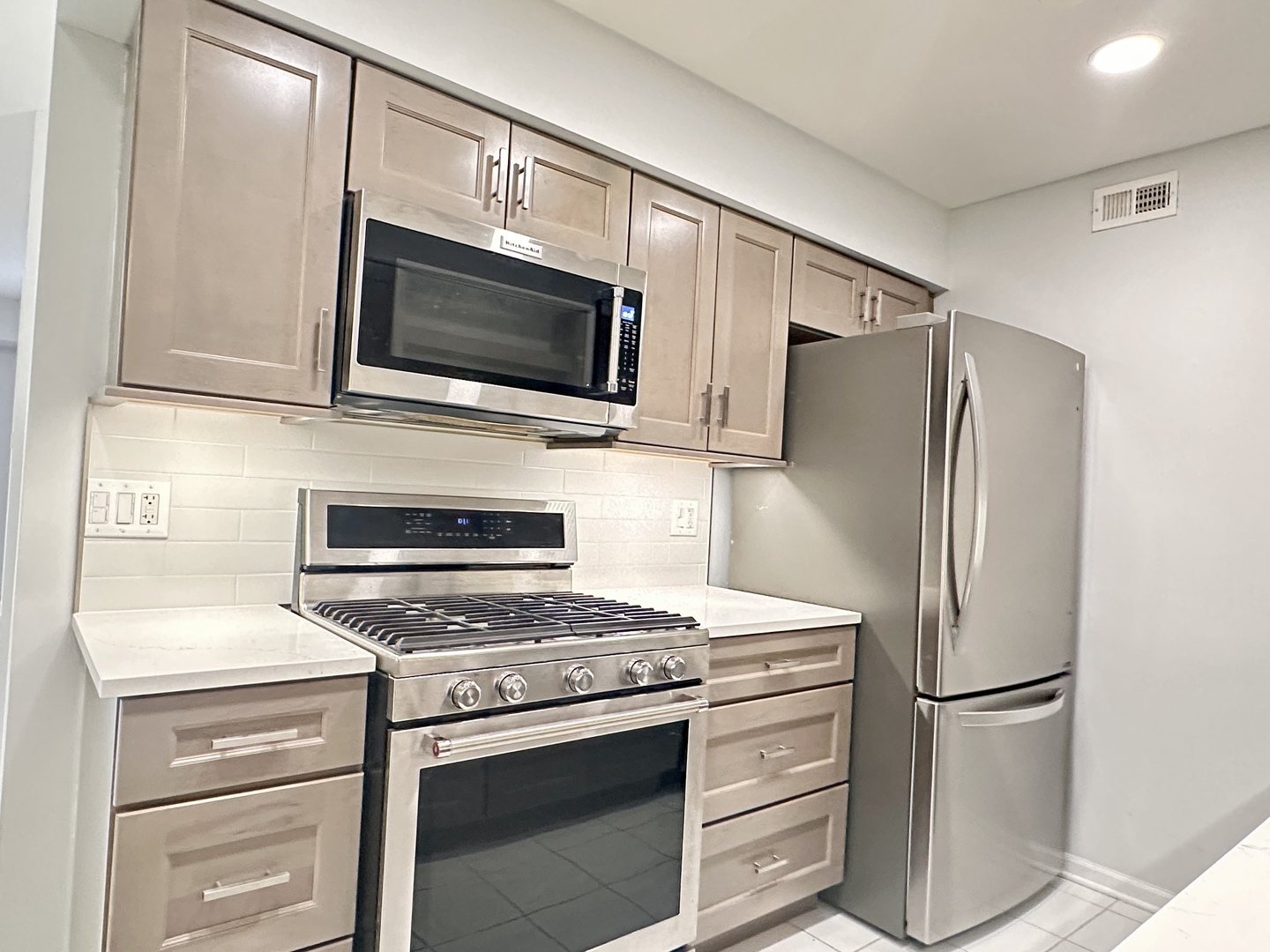 1603 North Windsor Drive, Unit 102 Arlington Heights, IL 60004 - Photo 5 of 18 a kitchen with a stove microwave and refrigerator