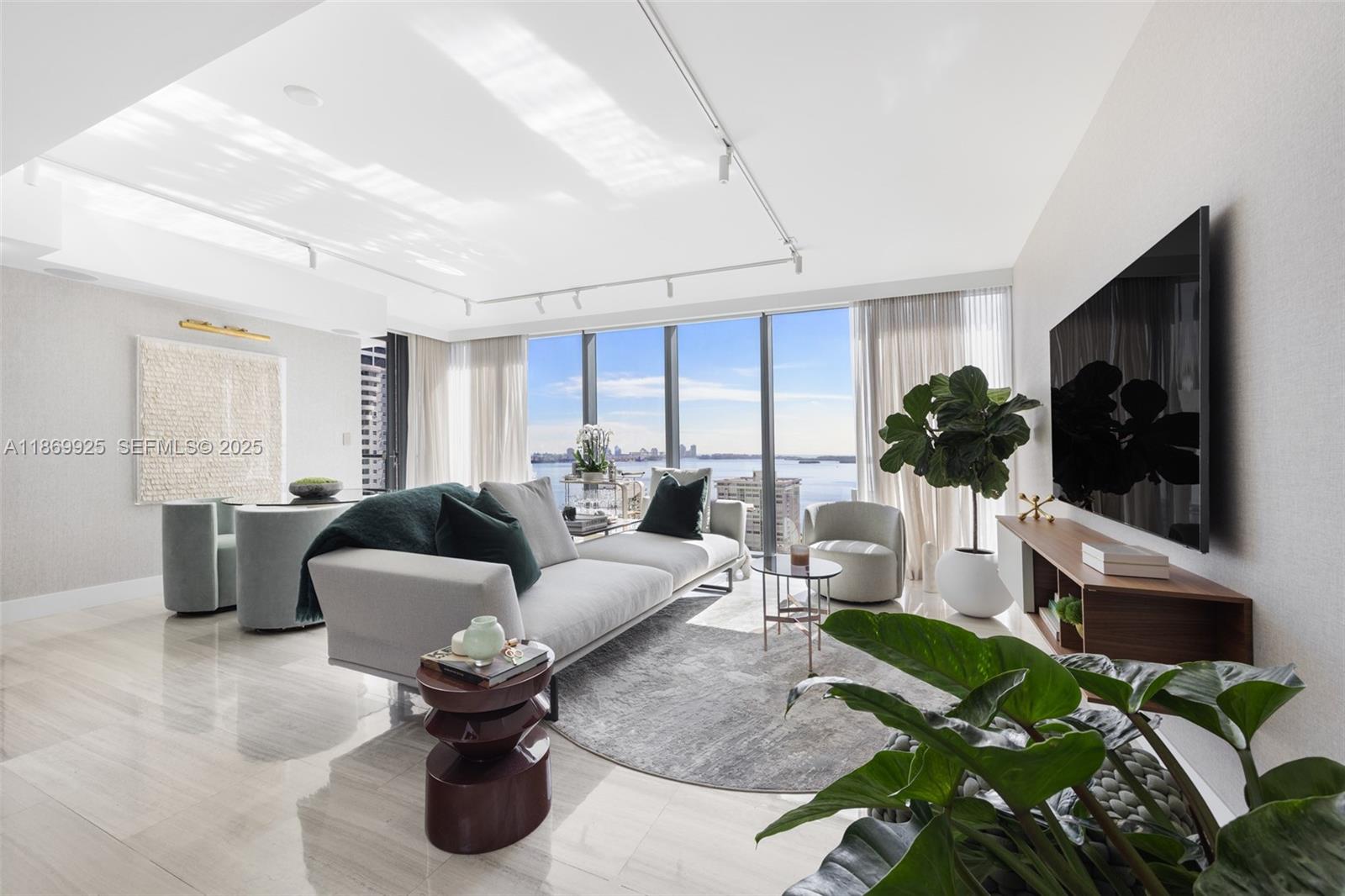 1451 Brickell Avenue, Unit 1901 Miami, FL 33131 - Photo 1 of 31 a living room with furniture a flat screen tv and a large window