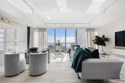 a bedroom with a bed and a television