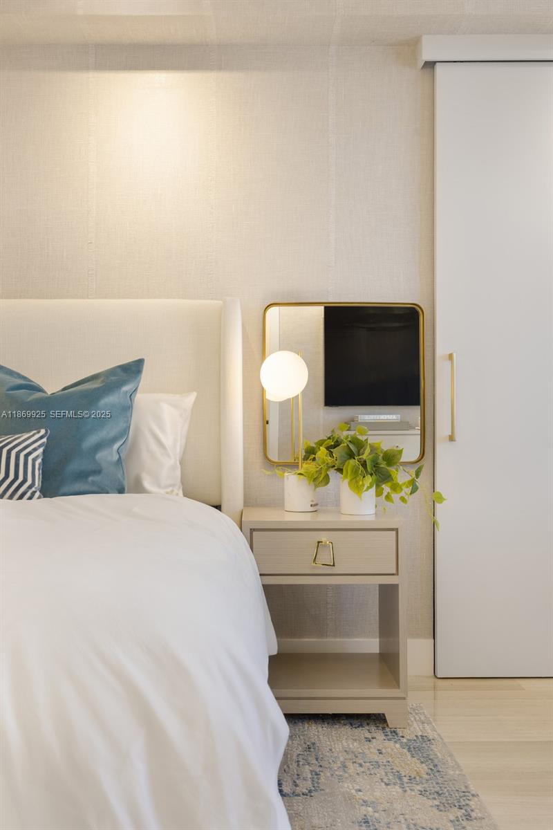 1451 Brickell Avenue, Unit 1901 Miami, FL 33131 - Photo 15 of 31 a bedroom with a bed and a television