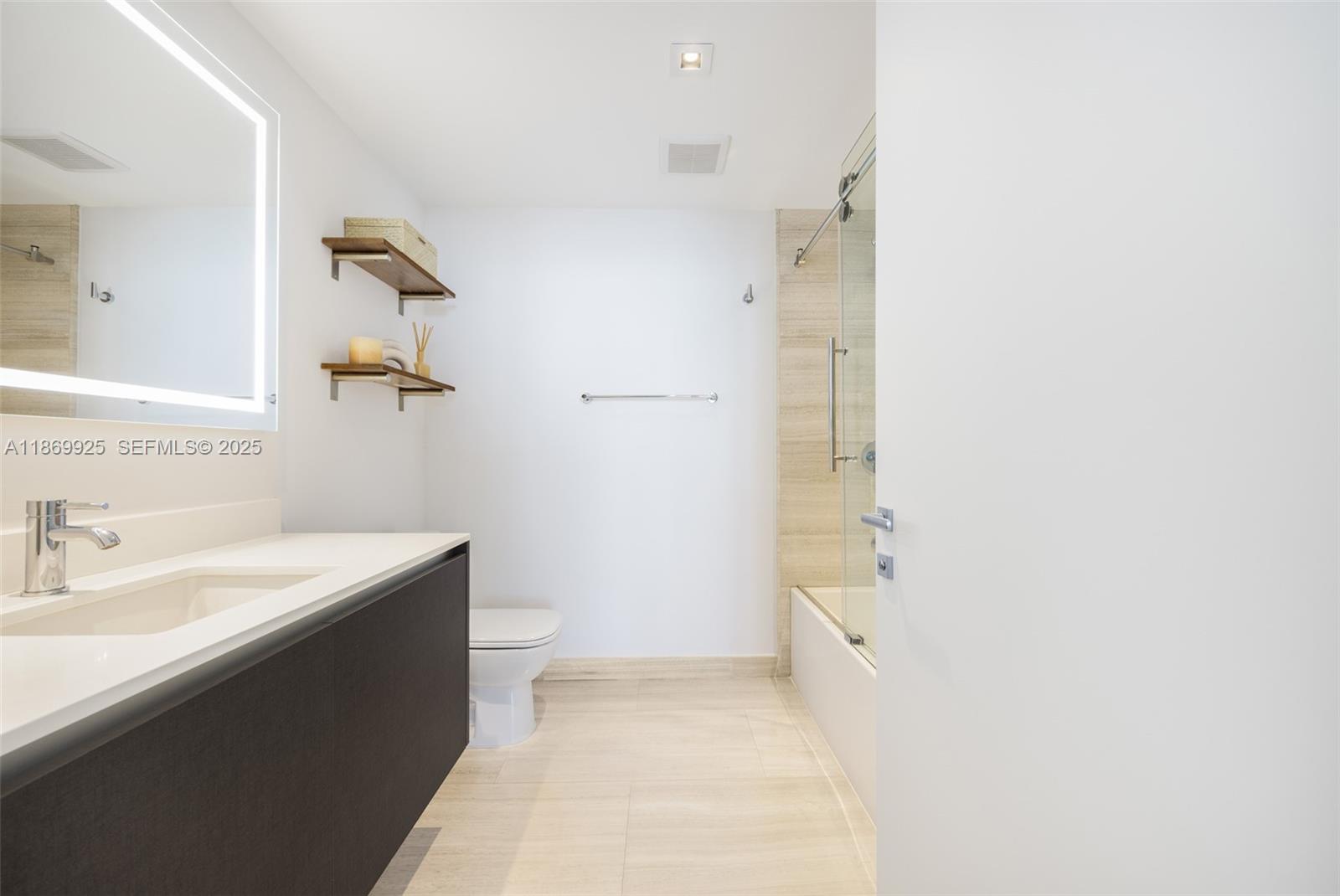 1451 Brickell Avenue, Unit 1901 Miami, FL 33131 - Photo 17 of 31 a bathroom with a sink a toilet and shower