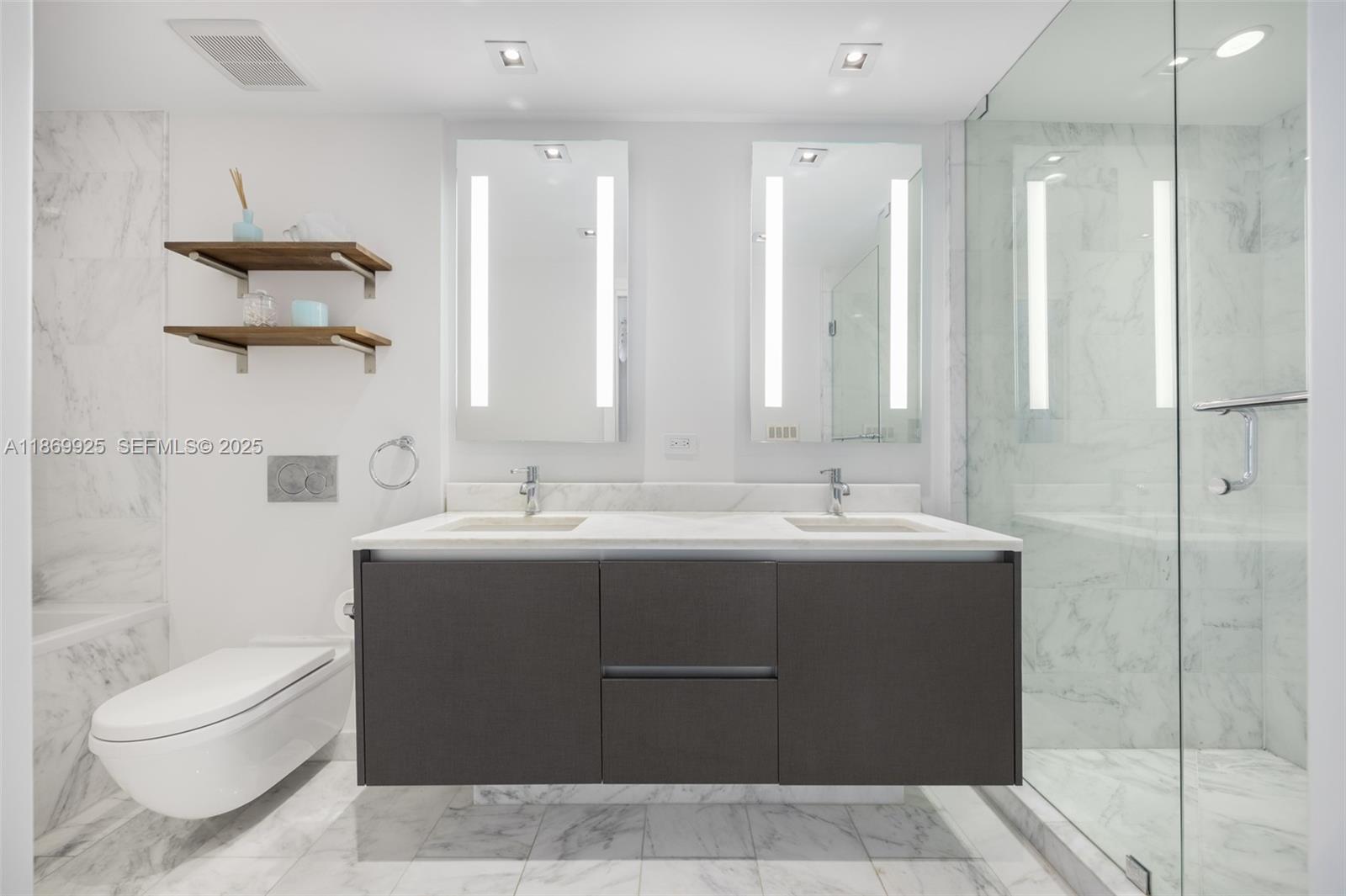 1451 Brickell Avenue, Unit 1901 Miami, FL 33131 - Photo 19 of 31 a bathroom with a sink toilet and shower