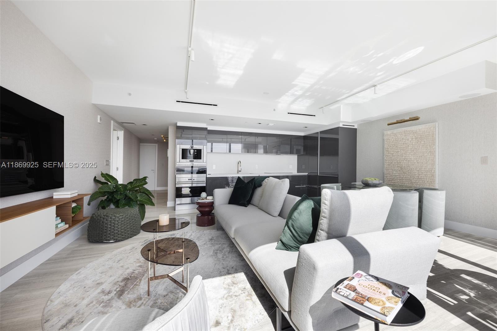 1451 Brickell Avenue, Unit 1901 Miami, FL 33131 - Photo 2 of 31 a living room with furniture and a flat screen tv