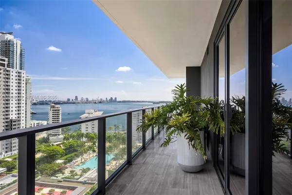 a view of a balcony with lake view and a potted plant