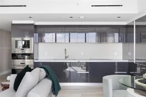 a kitchen with stainless steel appliances granite countertop a refrigerator and a stove