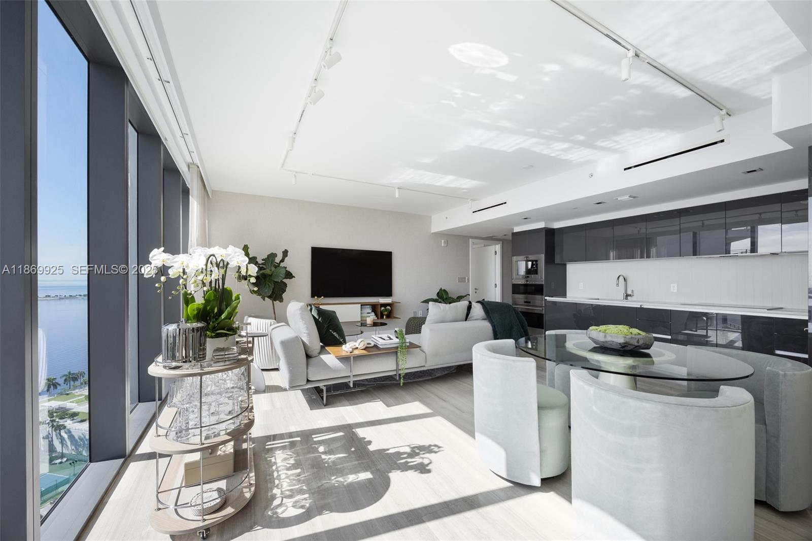 1451 Brickell Avenue, Unit 1901 Miami, FL 33131 - Photo 9 of 31 a living room with furniture and a flat screen tv