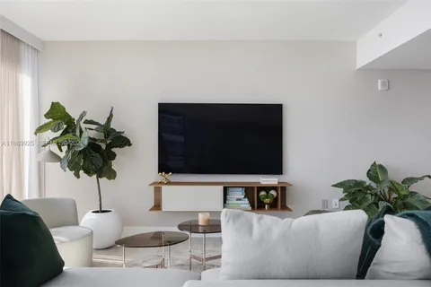 a living room with furniture a lamp and a large window