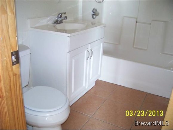 3299 Northeast Jackson Palm Bay, FL 32905 - Photo 3 of 12 a bathroom with a granite countertop sink toilet and a mirror