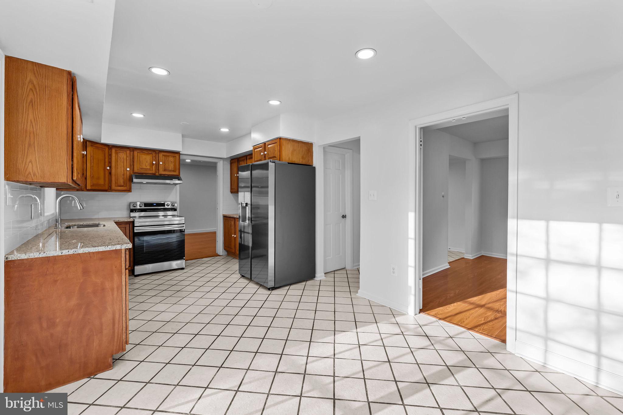 4001 Middle Ridge Drive Fairfax, VA 22033 - Photo 11 of 49 a kitchen with stainless steel appliances a refrigerator and a stove top oven