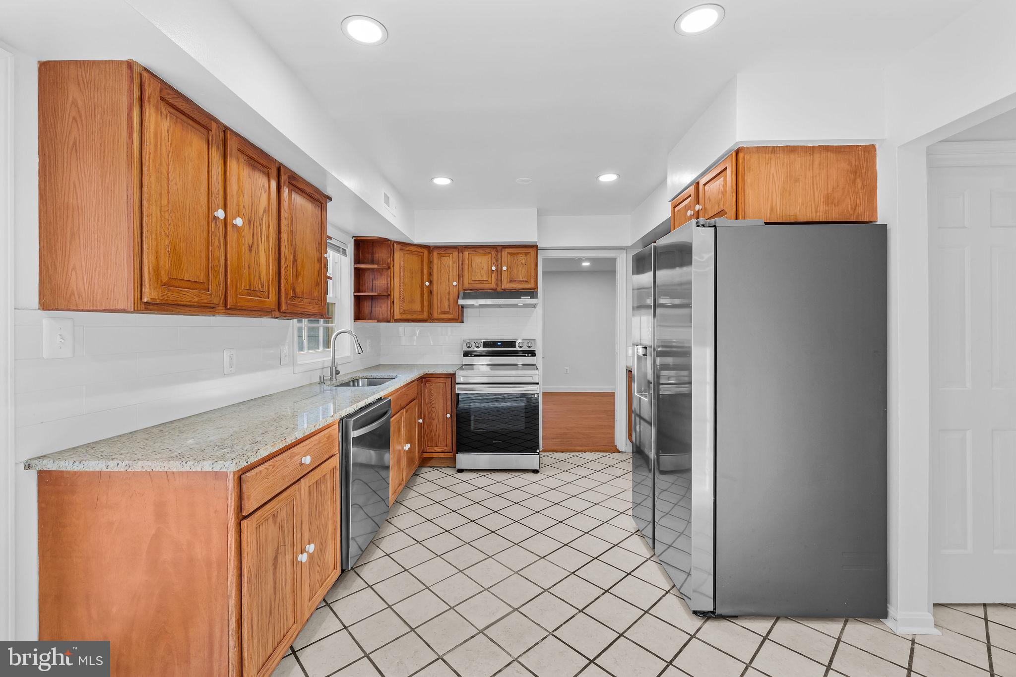 4001 Middle Ridge Drive Fairfax, VA 22033 - Photo 12 of 49 a kitchen with stainless steel appliances granite countertop a refrigerator and a stove
