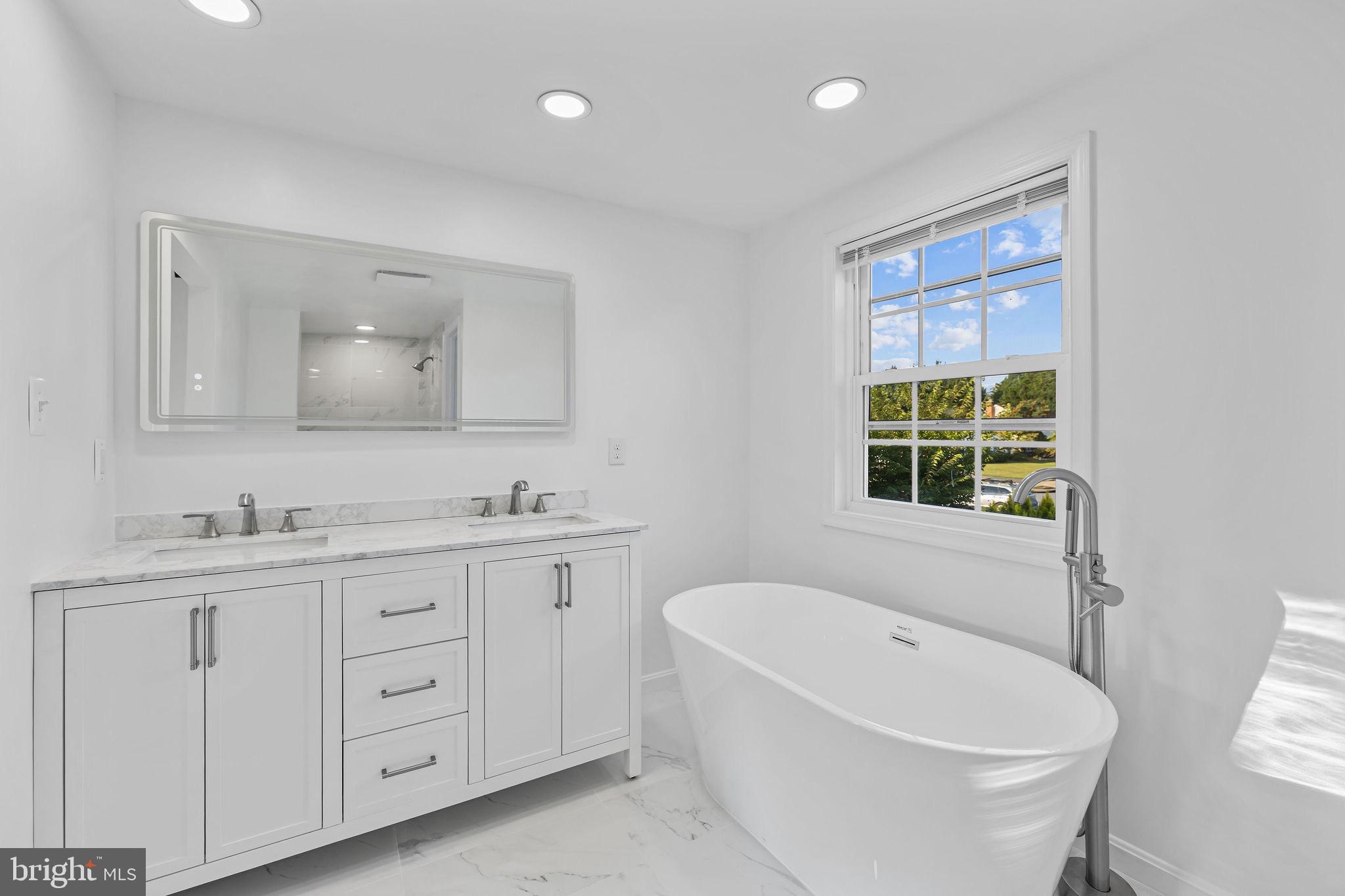 4001 Middle Ridge Drive Fairfax, VA 22033 - Photo 36 of 49 a bathroom with a granite countertop sink a toilet and bathtub