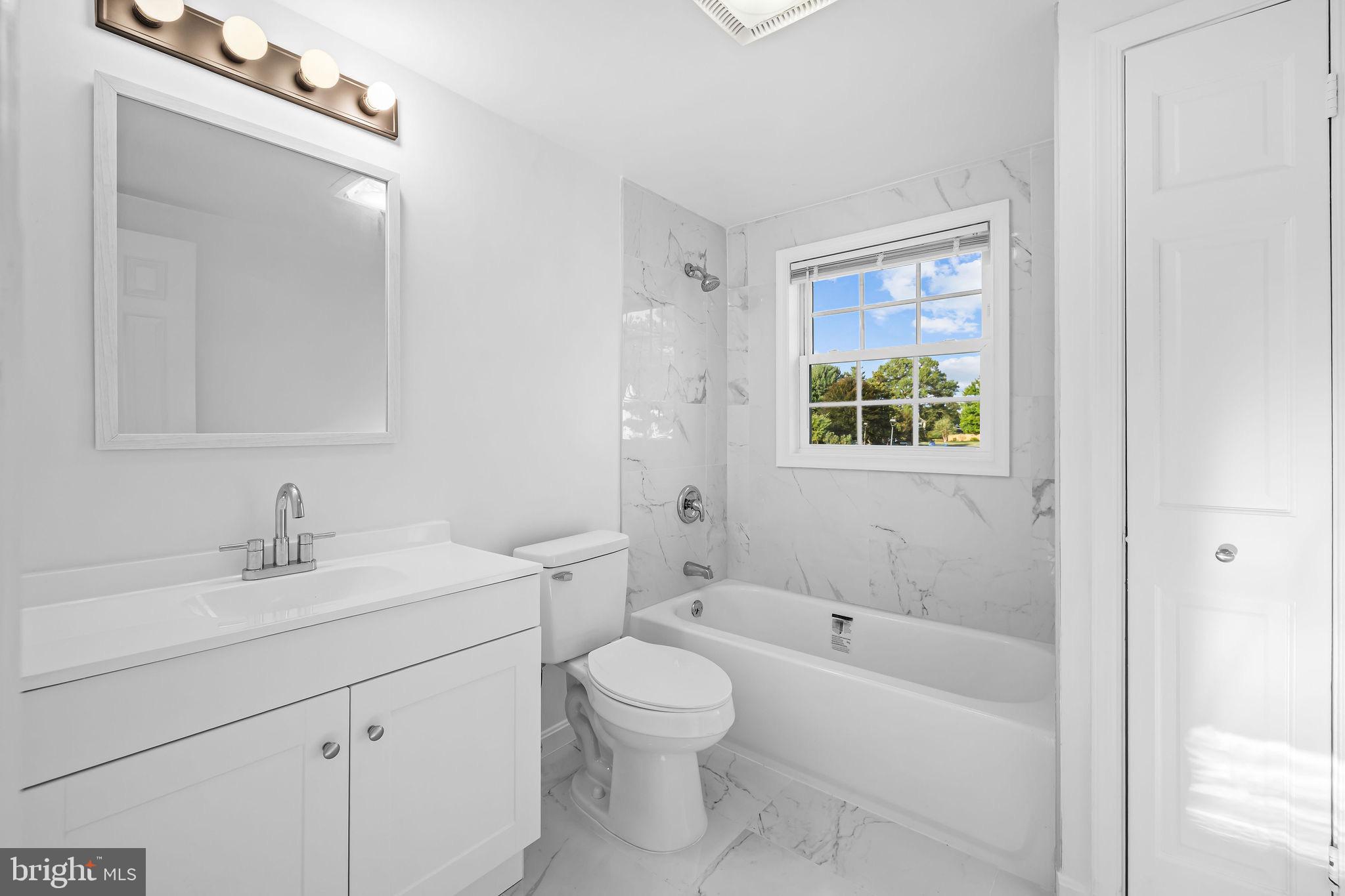 4001 Middle Ridge Drive Fairfax, VA 22033 - Photo 39 of 49 a bathroom with a toilet a sink a mirror and a bathtub