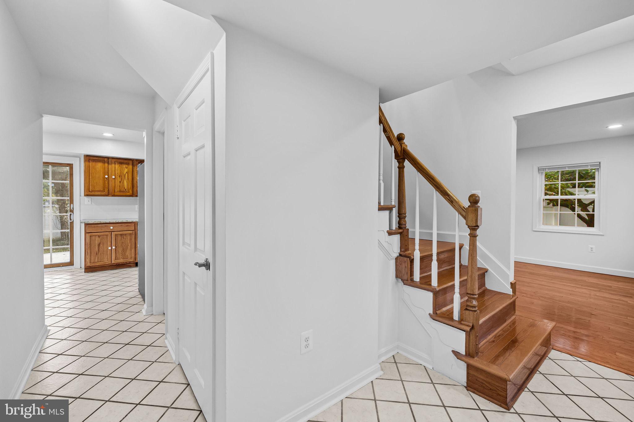 4001 Middle Ridge Drive Fairfax, VA 22033 - Photo 9 of 49 a view of an entryway with wooden floor leading to a furnished livingroom and windows