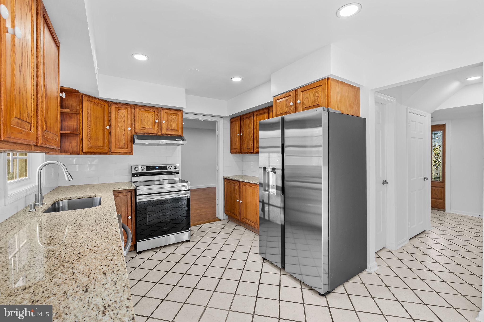 4001 Middle Ridge Drive Fairfax, VA 22033 - Photo 10 of 49 a kitchen with stainless steel appliances granite countertop a refrigerator and a stove top oven