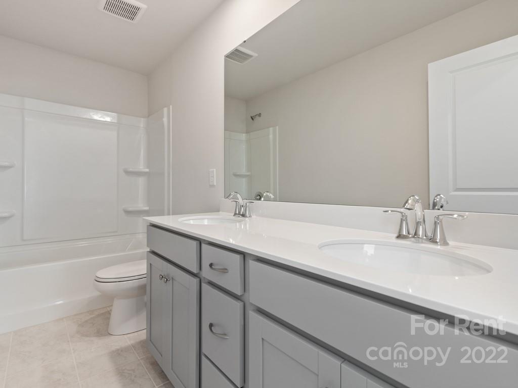6531 Gopher Road Lancaster, SC 29720 - Photo 16 of 29 a bathroom with a double vanity sink toilet and a tub