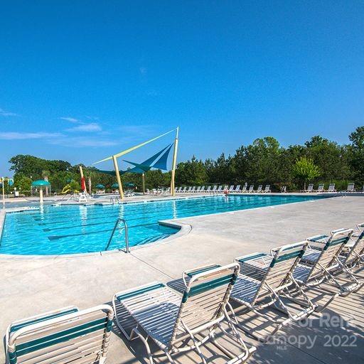 6531 Gopher Road Lancaster, SC 29720 - Photo 26 of 29 a view of swimming pool with lawn chairs and wooden fence