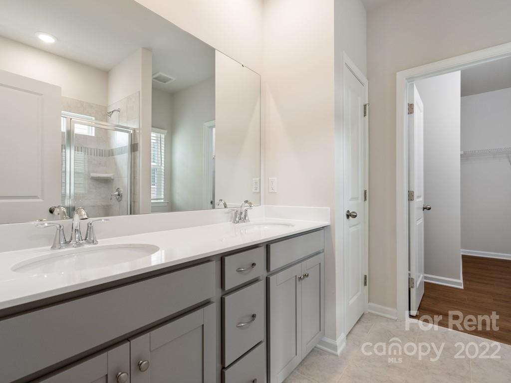 6531 Gopher Road Lancaster, SC 29720 - Photo 10 of 29 a bathroom with a double vanity sink and a mirror