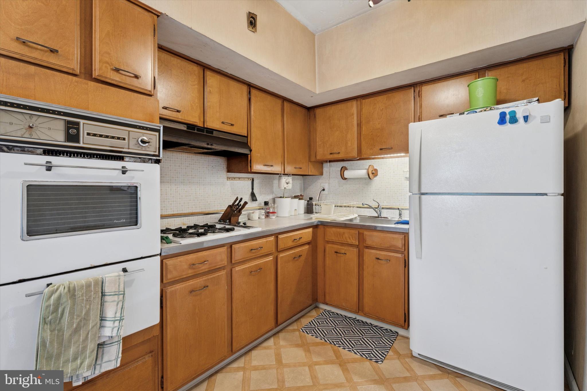 718 Cherry Street Lansdale, PA 19446 - Photo 13 of 23 a kitchen with stainless steel appliances granite countertop a refrigerator and a sink