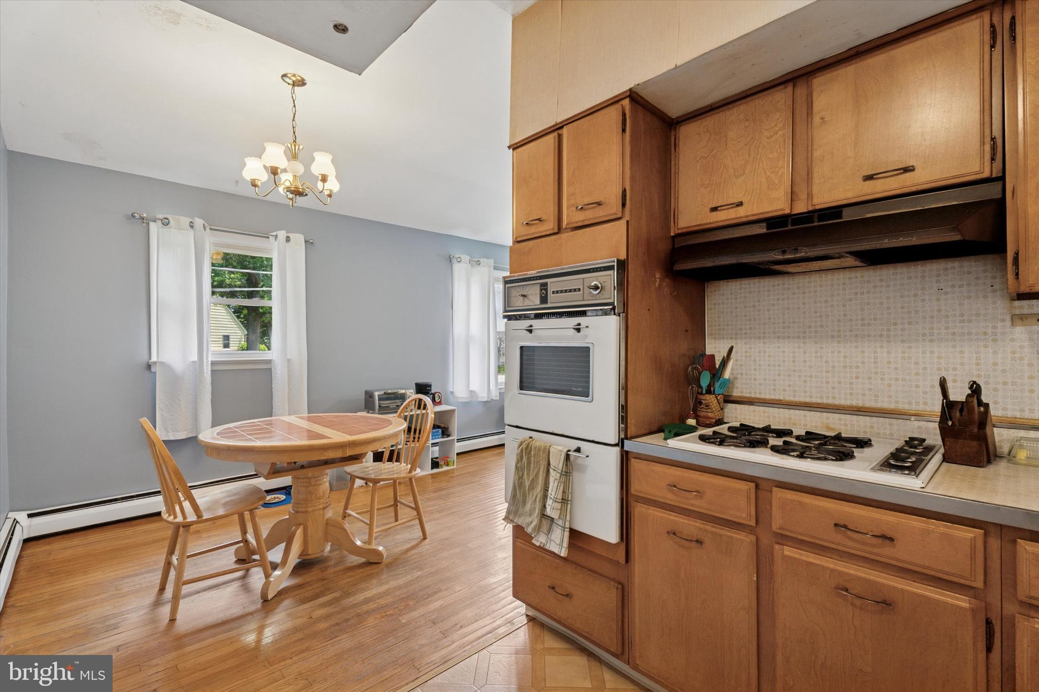 718 Cherry Street Lansdale, PA 19446 - Photo 14 of 23 a kitchen with stainless steel appliances granite countertop a stove a sink dishwasher and cabinets with wooden floor