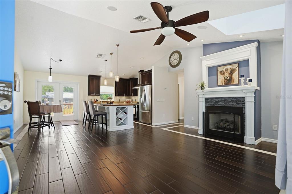 7037 County Road 625 Bushnell, FL 33513 - Photo 11 of 99 an open kitchen with furniture and a fireplace