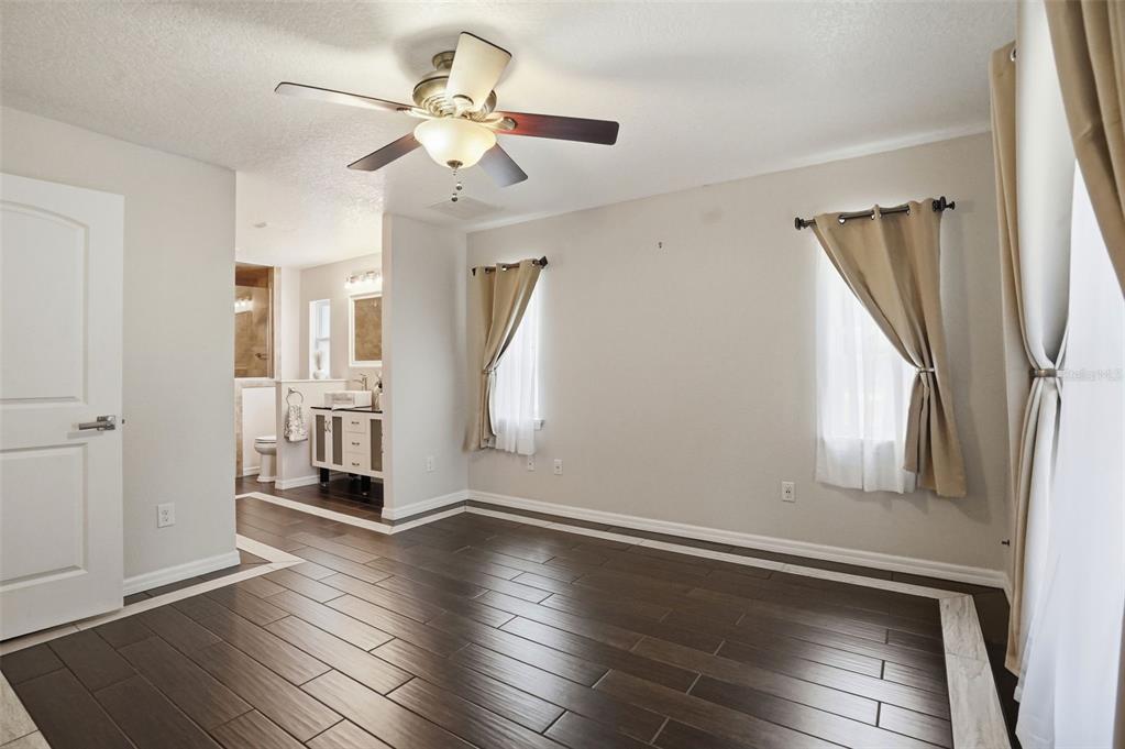 7037 County Road 625 Bushnell, FL 33513 - Photo 17 of 99 wooden floor in an empty room with a window