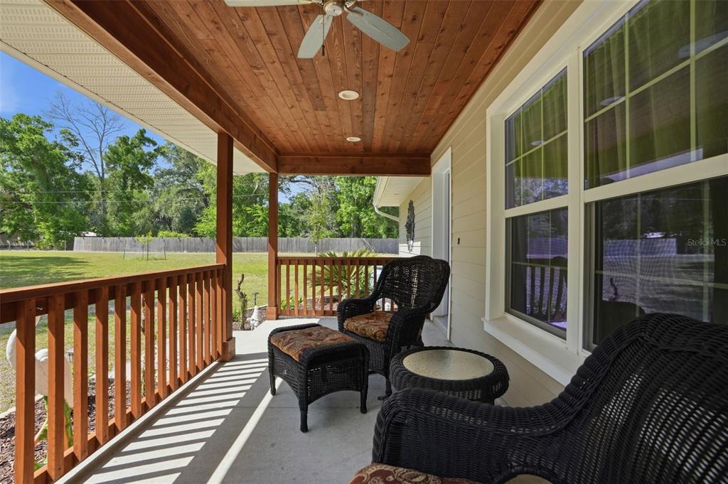 7037 County Road 625 Bushnell, FL 33513 - Photo 18 of 99 a view of a porch with furniture and wooden floor