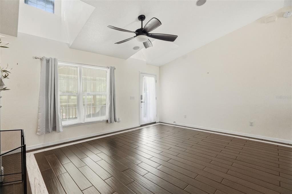 7037 County Road 625 Bushnell, FL 33513 - Photo 22 of 99 wooden floor in an empty room with a window