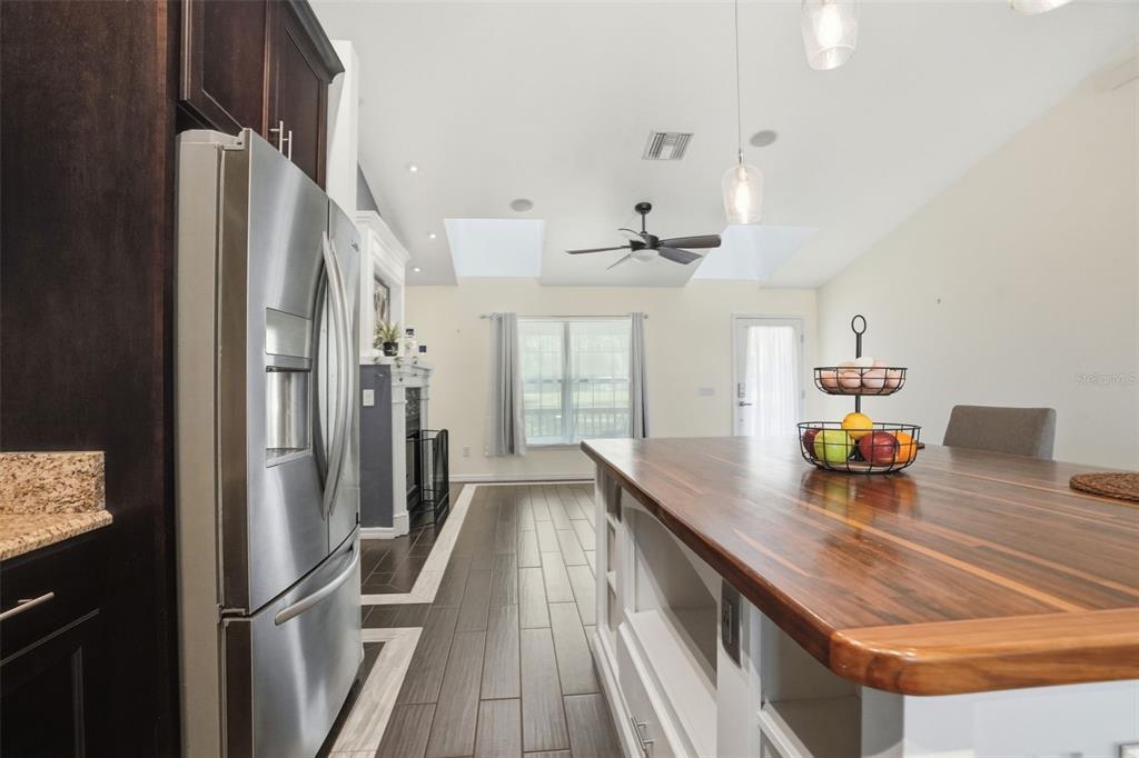 7037 County Road 625 Bushnell, FL 33513 - Photo 28 of 99 a kitchen with stainless steel appliances granite countertop a refrigerator and a sink