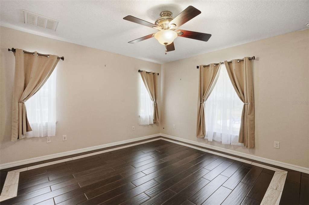 7037 County Road 625 Bushnell, FL 33513 - Photo 34 of 99 a view of an empty room with wooden floor and a window
