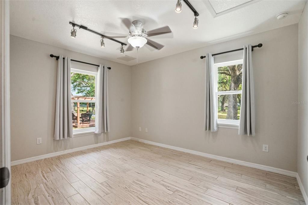 7037 County Road 625 Bushnell, FL 33513 - Photo 46 of 99 a view of an empty room with wooden floor and a window