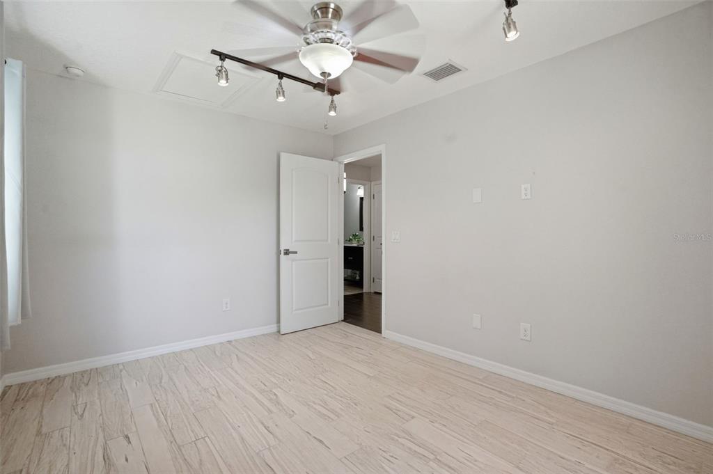 7037 County Road 625 Bushnell, FL 33513 - Photo 47 of 99 wooden floor in an empty room with a fan